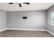 Bedroom with neutral walls, wood-look floors, a ceiling fan, and a window with blinds at 8555 112Th St # 209, Seminole, FL 33772