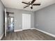 Bedroom with neutral walls, wood-look floors, a ceiling fan, and a closet with bifold doors at 8555 112Th St # 209, Seminole, FL 33772