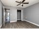 Bedroom with neutral walls, wood-look floors, a ceiling fan, and a closet with bifold doors at 8555 112Th St # 209, Seminole, FL 33772