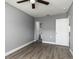A spacious bedroom with a ceiling fan, wood-look flooring and a walk-in closet at 8555 112Th St # 209, Seminole, FL 33772
