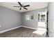 Bedroom with neutral walls, wood-look floors, a ceiling fan and an entry to the screened in porch at 8555 112Th St # 209, Seminole, FL 33772
