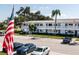 Exterior view of the building featuring a balcony and well-maintained landscaping at 8555 112Th St # 209, Seminole, FL 33772