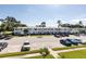 Exterior view of building featuring well manicured green spaces and parking at 8555 112Th St # 209, Seminole, FL 33772