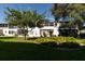 Exterior facade of building with mature landscaping and large manicured lawn at 8555 112Th St # 209, Seminole, FL 33772