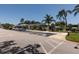 Exterior view of a community center with palm trees, parking, and manicured landscaping under a clear sky at 8555 112Th St # 209, Seminole, FL 33772