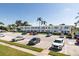 Apartment complex with a large parking lot, tropical landscaping, blue accents, and white exterior at 8555 112Th St # 209, Seminole, FL 33772