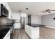 Updated kitchen featuring white cabinets, black countertop island, and stainless steel appliances at 8555 112Th St # 209, Seminole, FL 33772