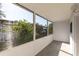 Enclosed porch featuring a view of mature trees, exterior building and a gray tiled floor at 8555 112Th St # 209, Seminole, FL 33772