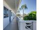 Exterior building walkway, featuring palm trees, landscaping and blue doors at 8555 112Th St # 209, Seminole, FL 33772