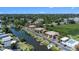 Aerial view of waterfront property featuring serene canals, lush landscaping and community pool at 10216 Seminole Island Dr, Largo, FL 33773