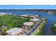 Breathtaking aerial view of waterfront condos with boat docks, overlooking a tranquil lake and lush landscape at 10216 Seminole Island Dr, Largo, FL 33773