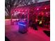 Backyard patio with a stainless steel grill, overhead pergola, and vibrant pink string lights at 10216 Seminole Island Dr, Largo, FL 33773