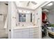 Bright bathroom features a white vanity with storage and a large mirror at 10216 Seminole Island Dr, Largo, FL 33773
