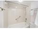 Standard white tiled bath and shower combination at 10216 Seminole Island Dr, Largo, FL 33773