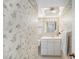 Charming bathroom with floral wallpaper, a vanity, and a well-lit mirror at 10216 Seminole Island Dr, Largo, FL 33773