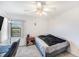 Cozy bedroom featuring plush carpeting, a ceiling fan, and a window providing natural light at 10216 Seminole Island Dr, Largo, FL 33773
