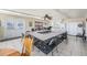 Well-lit common room featuring tile floors, a kitchen, and large tables for community gatherings and activities at 10216 Seminole Island Dr, Largo, FL 33773