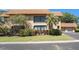 Two-story condo boasting a tile roof, an upper deck, and lush landscaping at 10216 Seminole Island Dr, Largo, FL 33773