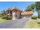Spacious two-story home with a tile roof, three-car garage, and well-maintained landscaping at 10216 Seminole Island Dr, Largo, FL 33773