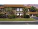 Two-story condo boasting a tile roof, an upper deck, and lush landscaping at 10216 Seminole Island Dr, Largo, FL 33773