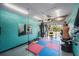 Bright home gym featuring a punching bag, weights, and a padded floor for workouts at 10216 Seminole Island Dr, Largo, FL 33773