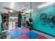 Bright home gym featuring a punching bag, weights, and a padded floor for workouts at 10216 Seminole Island Dr, Largo, FL 33773