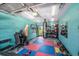 Bright home gym featuring a punching bag, weights, and a padded floor for workouts at 10216 Seminole Island Dr, Largo, FL 33773