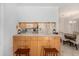 View of the kitchen bar with wood cabinets overlooking the open-concept dining room at 10216 Seminole Island Dr, Largo, FL 33773