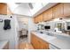 Open kitchen featuring wood cabinets, laminate countertops, and view of living area at 10216 Seminole Island Dr, Largo, FL 33773