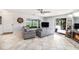 Open-concept living room with sliding glass doors and a cozy fireplace at 10216 Seminole Island Dr, Largo, FL 33773