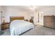 Bright main bedroom with wood furniture, carpet, and ensuite bathroom at 10216 Seminole Island Dr, Largo, FL 33773