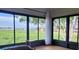 Sun room with expansive windows offering a serene view of the lush landscape and waterfront at 10216 Seminole Island Dr, Largo, FL 33773