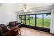 Light-filled sunroom with large windows offering serene views of the lush surroundings at 10216 Seminole Island Dr, Largo, FL 33773