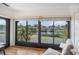 Sunroom with large windows overlooking the water at 10216 Seminole Island Dr, Largo, FL 33773