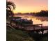 Boating at Sunrise: Dock with Boat on a serene waterfront, making it a boater's paradise at 10216 Seminole Island Dr, Largo, FL 33773