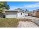 Exterior backyard view features a backyard and driveway in a well-lit outdoor setting at 104 W South Ave, Tampa, FL 33603