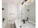 Modern bathroom featuring marble-look shower, tiled floors, and a vanity with black hardware at 104 W South Ave, Tampa, FL 33603