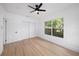 Well-lit bedroom boasts hardwood floors, a ceiling fan, a window, and double closets for ample storage at 104 W South Ave, Tampa, FL 33603