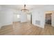Bright dining area showcasing wood-look floors and an elegant hanging light fixture at 104 W South Ave, Tampa, FL 33603