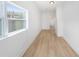 Neutral empty room bathed in sunlight with modern light wood flooring and fresh white walls at 104 W South Ave, Tampa, FL 33603