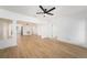 Spacious living room with neutral walls and flooring, illuminated by a modern ceiling fan at 104 W South Ave, Tampa, FL 33603