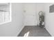 Functional utility room featuring tiled floor, window, and a water heater at 104 W South Ave, Tampa, FL 33603
