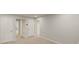 Upstairs hallway featuring neutral carpet, multiple doors, and access to rooms at 1143 Creek Valley Ct, Brandon, FL 33511