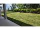 A lush, green backyard enclosed by a sleek, modern black fence, offering privacy and space at 11884 Richmond Trl, Parrish, FL 34219