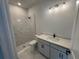 Modern bathroom featuring a vanity sink, toilet, and glass-enclosed shower with white marble-style tile at 11884 Richmond Trl, Parrish, FL 34219