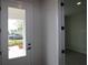 Bright entryway with a view of the front porch and well-manicured lawn at 11884 Richmond Trl, Parrish, FL 34219