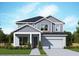 Two-story home featuring a modern design, well-manicured lawn, and integrated two-car garage at 11884 Richmond Trl, Parrish, FL 34219