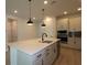 Bright kitchen featuring a spacious island, modern lighting, and stainless steel appliances at 11884 Richmond Trl, Parrish, FL 34219