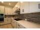 Kitchen with white cabinetry, granite countertops, and stainless steel appliances at 11884 Richmond Trl, Parrish, FL 34219