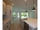 Modern kitchen with stainless steel appliances, a center island, and stylish pendant lighting at 11884 Richmond Trl, Parrish, FL 34219